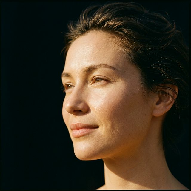 Close-up portrait of glowing, youthful vitality bathed in warm sunrise light